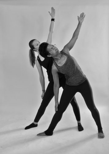 Photograph of 2 woman doing yoga. In front: Xandra, owner of 'Yotopia'