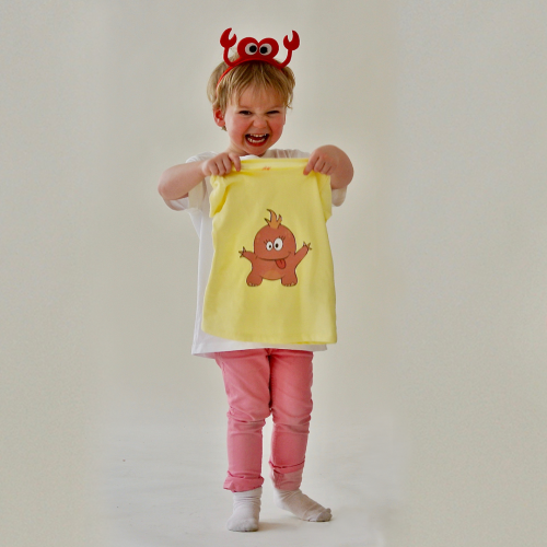 Photography of child holding shirt with monster print (photo and graphic design by SBP)