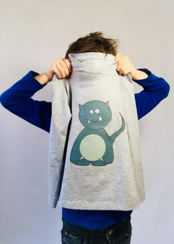 Photography of child holding shirt with monster print: 'Woektiedoedel' (photo and graphic design by SBP)